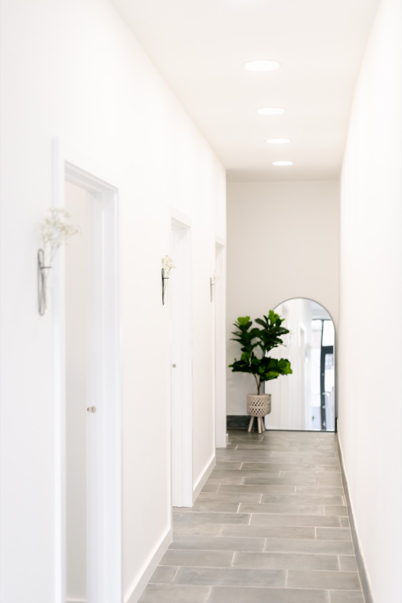 Bright clinic corridor leading to the treatment rooms