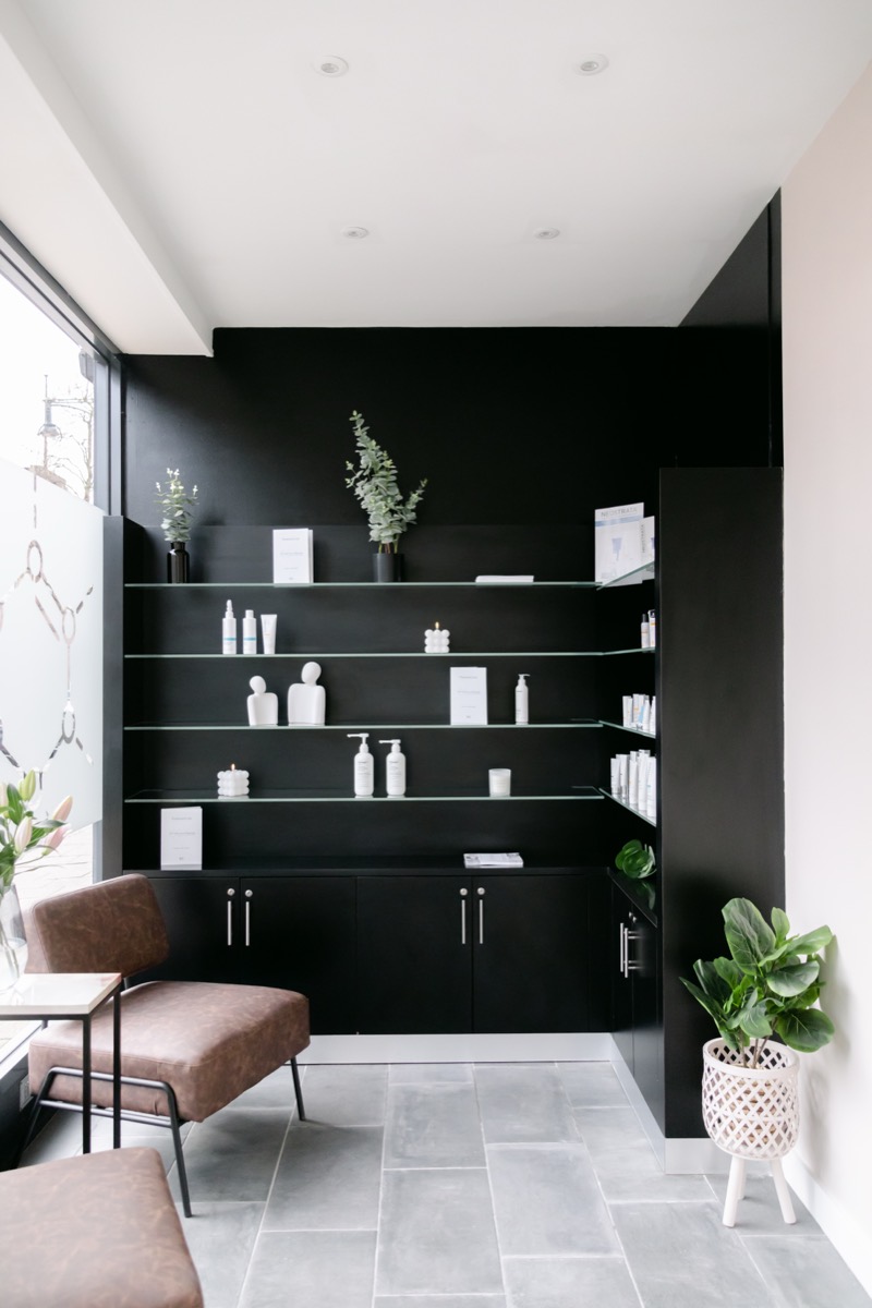 Clinic reception with skincare shelving and seating