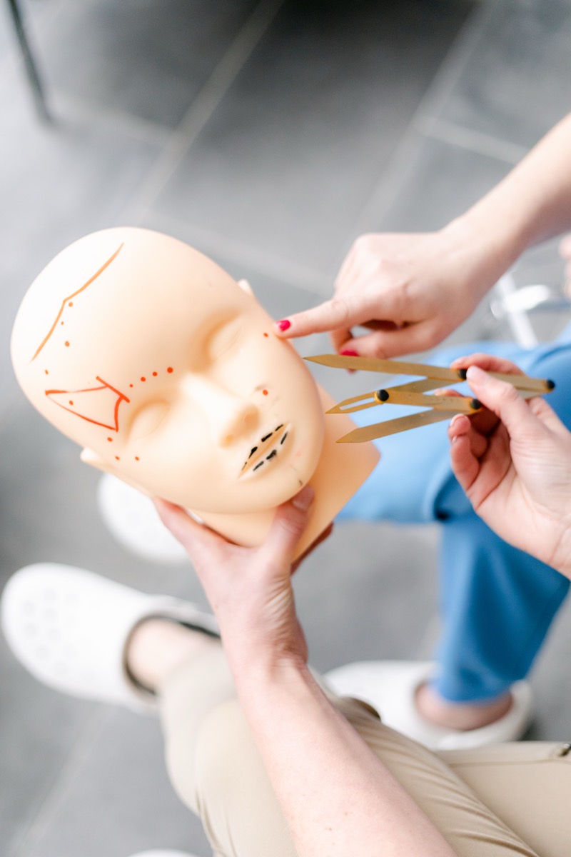 Facial mapping lines drawn on an anatomy training head during a course